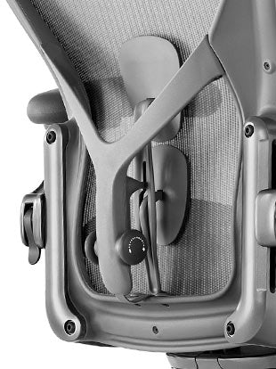 Rear view of a graphite Aeron office chair, showing back support and adjustable arms.