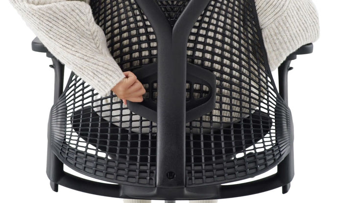 Close-up of seat adjustment controls on a mineral Aeron office chair