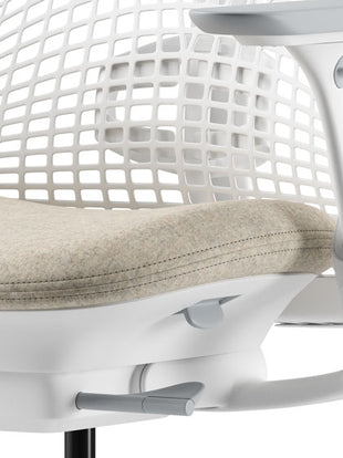Rear view of a graphite Aeron office chair, showing back support and adjustable arms.